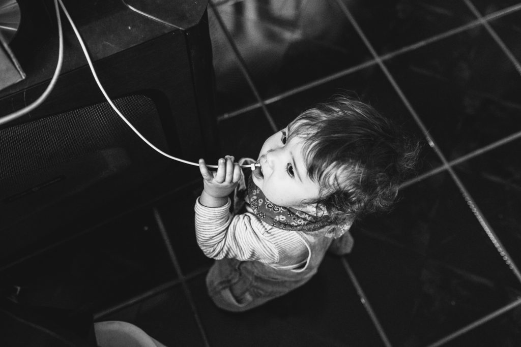 baby eating the computer cord