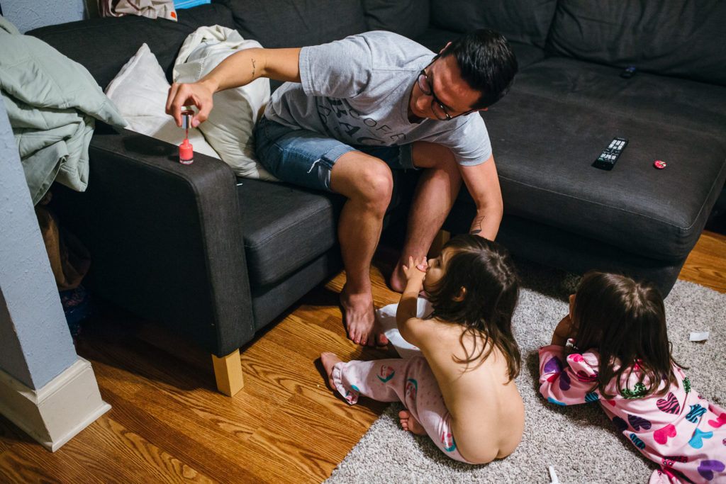 Daddy painting daughters nails