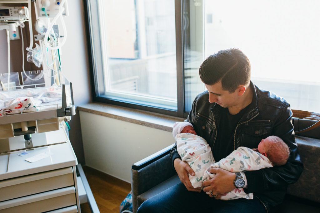 father holding twins