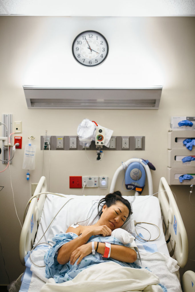 mother and newborn with clock