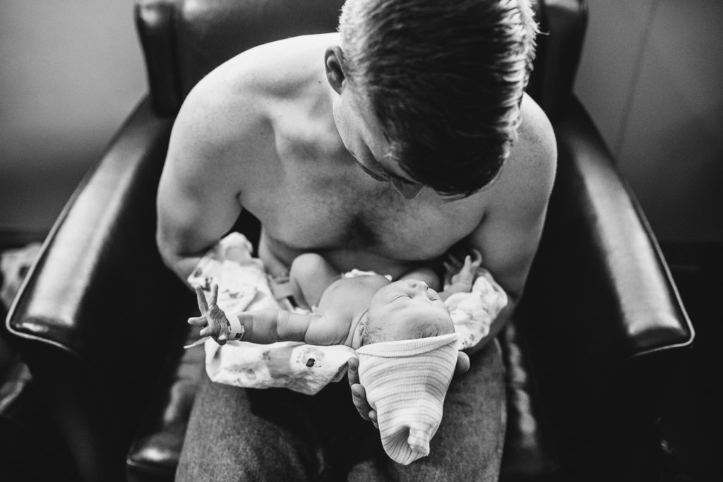 father holding newborn boy