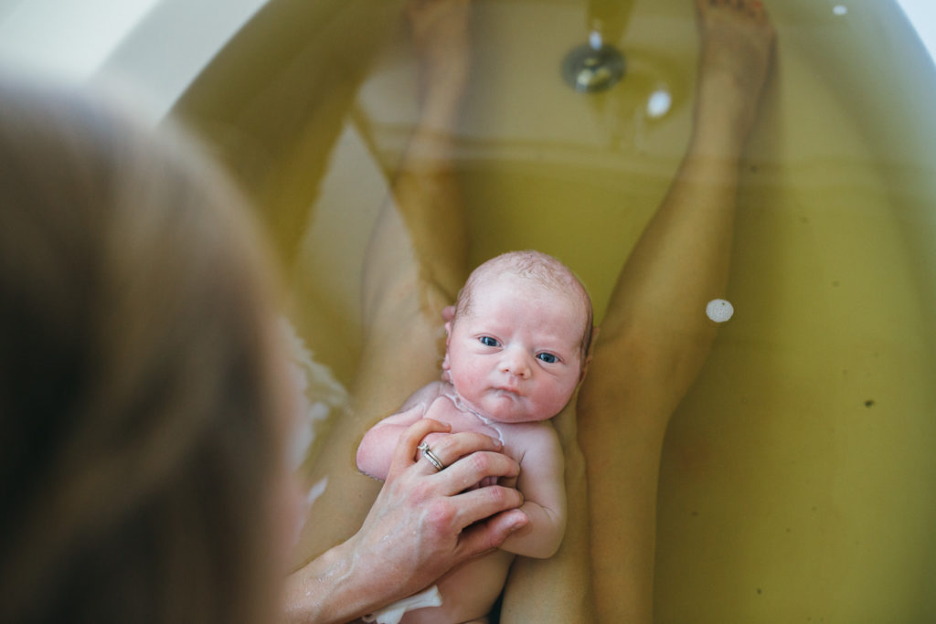 newborn in herbal bath