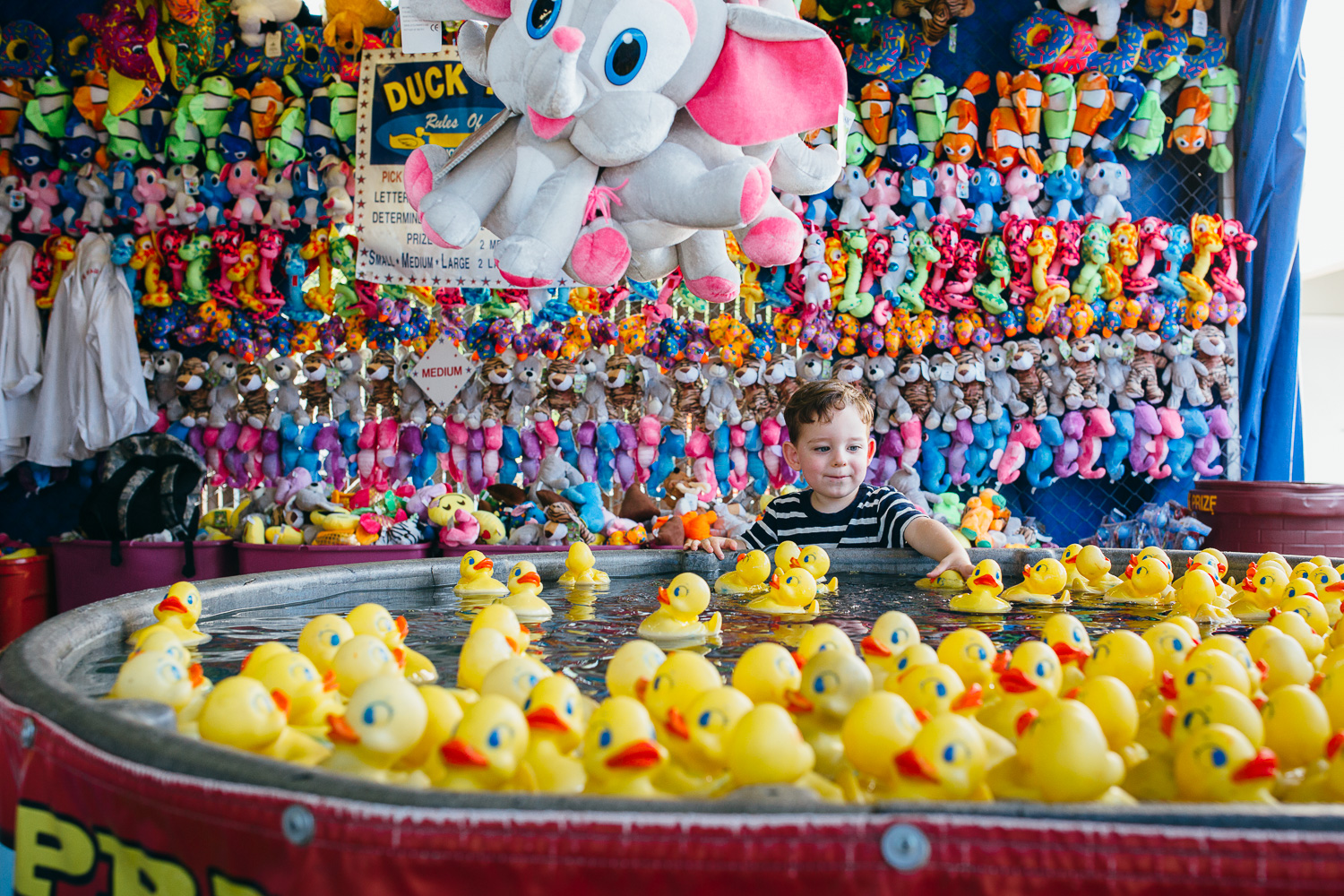 boy with rubber ducks at state fair of texas