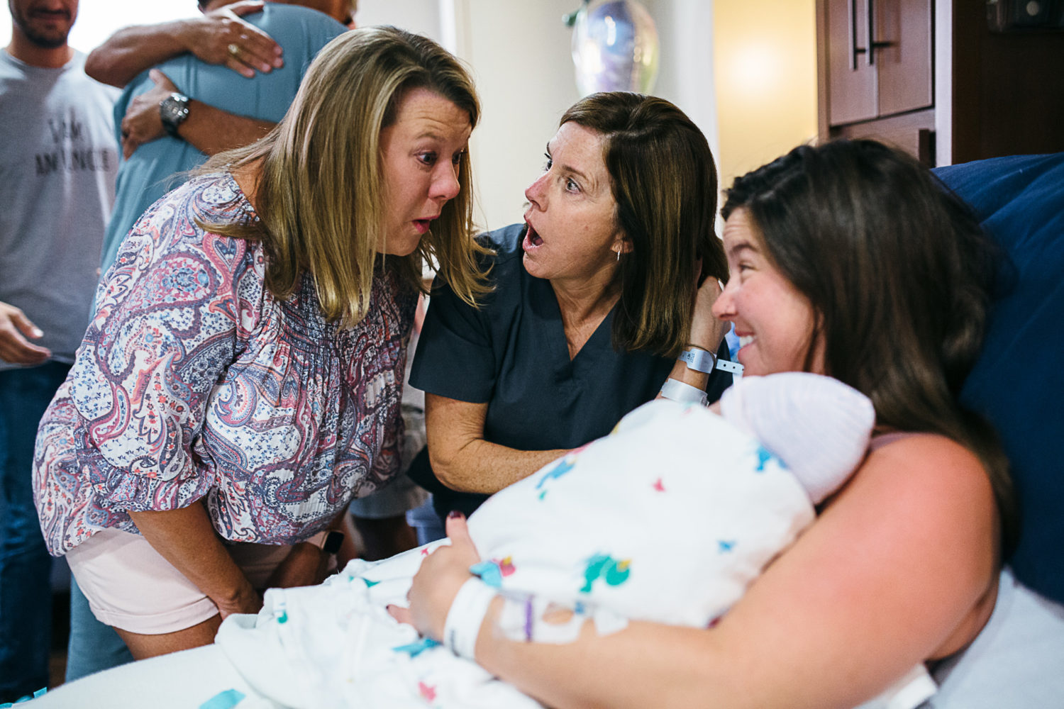 mom telling gender of newborn to family for the first time