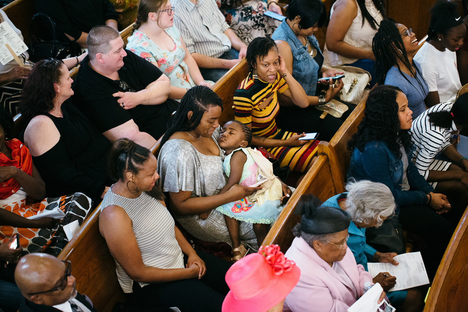 child sleeping on mother's lap at church service